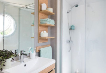 Modern bathroom at Lodge XL, Vakantiepark Bergumermeer, Netherlands, with shower and wood vanity unit.