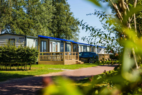 Casas de vacaciones modernas con terrazas y coche aparcado en Vakantiepark Bergumermeer, en Frisia, Países Bajos.