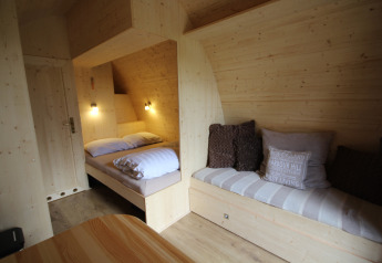 Cozy interior of a tiny wooden house, The Megapod VIP, at Camping De Grienduil in the Netherlands.