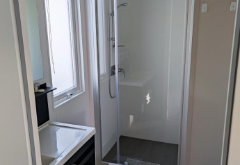 Bagno moderno con cabina doccia, lavandino, specchio e asciugamani a Luxe Homes, Bospark De Brenkberg, Paesi Bassi.