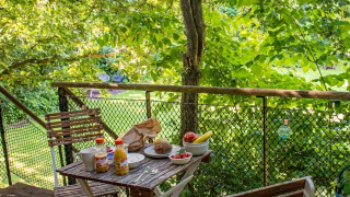 Ontbijt buiten op een knus terras omringd door groen in vakantiepark Buytenplaets Suydersee, Flevoland.