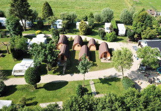Aerial view of Camping De Grienduil in Utrecht, Netherlands with cabins, caravans, and grassy areas.