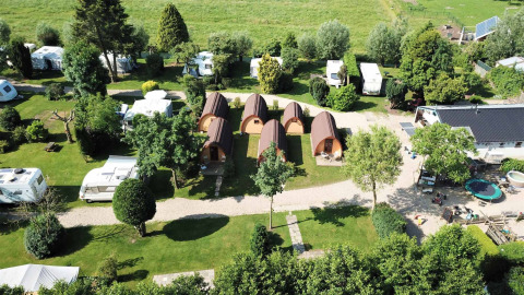 Aerial view of Camping De Grienduil in Utrecht, Netherlands with cabins, caravans, and grassy areas.