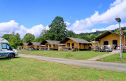 Tiendas safari en Camping Walsheim, Alemania, rodeadas de naturaleza y bajo un cielo azul brillante.