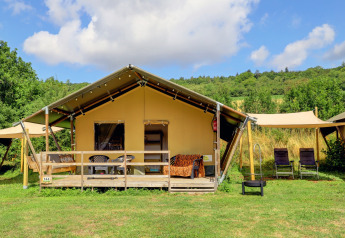 Tenda safari al Camping Walsheim in Germania, con veranda in legno e sedie nel verde.