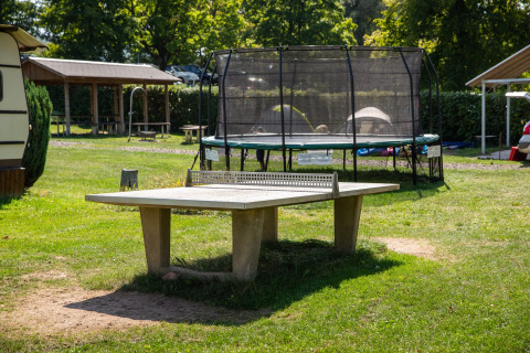 Mesa de tenis de mesa y trampolín al aire libre en Camping Walsheim, un parque vacacional en Saarland, Alemania.