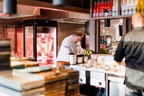 Chefs working in a modern kitchen at Vakantiepark Leukermeer, a holiday park in Limburg, Netherlands.