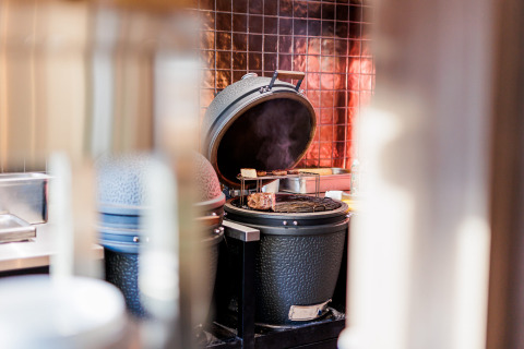 Parrilla abierta con comida cocinándose en Vakantiepark Leukermeer, parque vacacional en Limburg, Países Bajos.