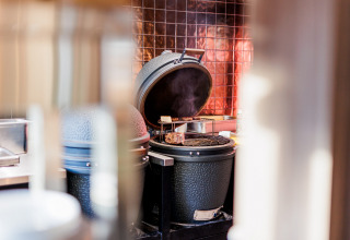 Open grill with food cooking at Vakantiepark Leukermeer, a holiday park in Limburg, Netherlands.