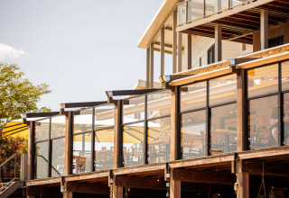 Outdoor terrace at Vakantiepark Leukermeer holiday park in Limburg, Netherlands, with modern architecture.