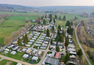 Aerial view of Camping Oos Heem holiday park in Liège, Belgium, with caravans and green fields around.