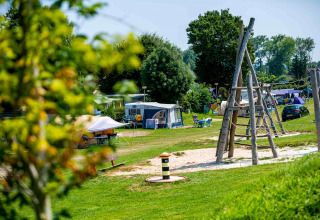 Playground and camping area at the scenic holiday park Camping Vinkenhof, Limburg, Netherlands, in summer.