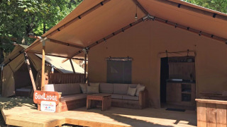 SunLodge Taiga&Kambi glamping tent with wooden deck at hu Norcenni Girasole Village in Italy.
