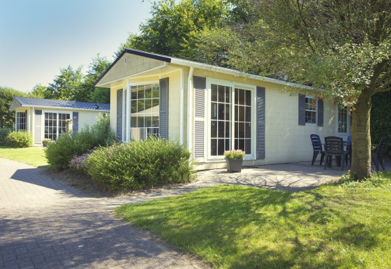 Bungalette basic + hot tub bij Holiday Park Mölke in Nederland, met tuin en uitnodigende terrasruimte.