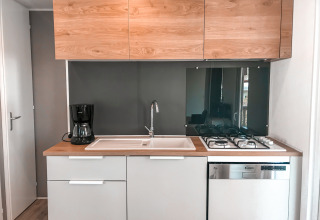 Moderne keuken in Forest Lodge met houten kasten, gootsteen, koffiezet, fornuis en vaatwasser.