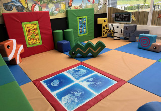 Indoor children's play area with colorful soft blocks and mats at Vakantiepark de Zeeuwse Parel, Zeeland.