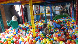 Children playing in a ball pit on an indoor playground at Camping Nieuw Romalo, Gelderland, Netherlands.