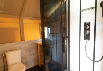 Bagno con wc e cabina doccia moderna in una tenda safari presso Eurocamping Vessem BV, Paesi Bassi.