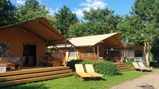 Foto van de SunLodge Yucca safaritent bij hu Birkelt Village in Luxemburg met terras en ligstoelen buiten.
