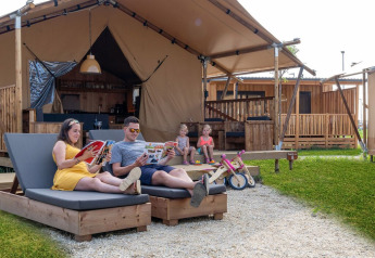 Gezin ontspant bij een luxe safaritent SunLodge Pamoja&Kambi op Camping Terme Catez in Slovenië.