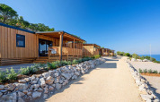 Sunny wooden lodges at SunLodge Catalpa in Camping Village Poljana, Croatia, overlooking the Adriatic Sea.