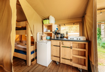 Indvendigt billede af et safari-telt på Camping Braunlage i Tyskland med køkken og køjeseng.