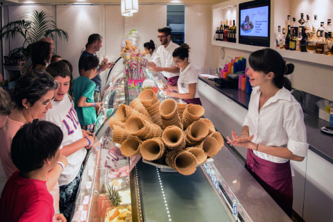 People choosing gelato at a counter in hu Norcenni Girasole Village holiday park in Tuscany, Italy.