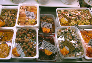 Selection of Italian antipasti and delicacies in oil at Norcenni Girasole Village in Tuscany, Italy.