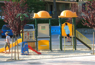 Bambini e adulti che giocano nel parco giochi al hu Norcenni Girasole Village, villaggio in Toscana.