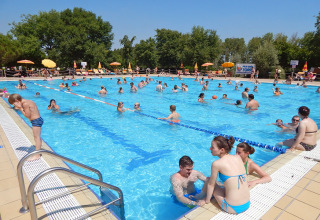 Outdoor swimming pool crowded with holidaymakers at Camping Pra'delle Torri holiday park in Veneto, Italy.