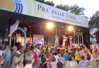 Crowd watching a live entertainment show at Camping Pra'delle Torri holiday park in Veneto, Italy.
