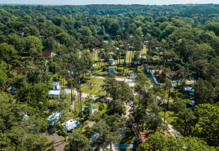 Aerial view of Buitencentrum Hessenheem holiday park surrounded by forest, caravans, and greenery in Overijssel.