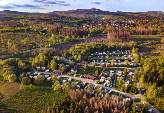 Aerial view of Camping Braunlage holiday park surrounded by forest and hills in Lower Saxony, Germany.