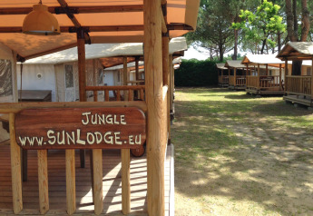 SunLodge Jungle cabins at Camping Union Lido Mare in Italy, wooden signs and outdoor seating visible.
