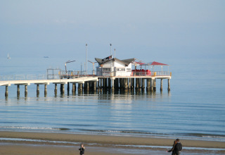 Pier with pavilion over calm sea at Camping Village Marina di Venezia holiday park, Veneto, Italy.