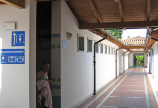 Corridor with restroom and shower signs at Camping Village Marina di Venezia holiday park in Veneto, Italy.