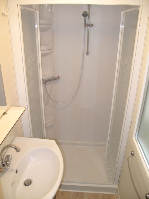 Modern shower cabin and sink in the bathroom at SunLodge Redwood, Camping Village Marina di Venezia, Italy.