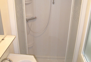 Modern shower cabin and sink in the bathroom at SunLodge Redwood, Camping Village Marina di Venezia, Italy.