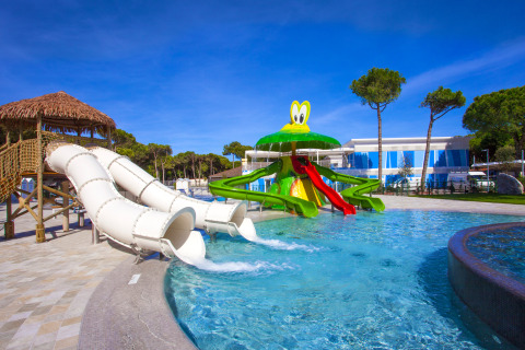 Parque acuático con toboganes y temática de rana en Camping Village Cavallino, parque vacacional en Véneto, Italia.