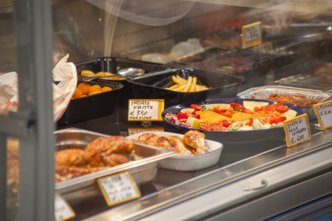 Buffet-style food including roast chicken, fries and salad at Camping Village Cavallino in Veneto, Italy.