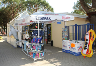 Outdoor shop at Camping Village Cavallino in Veneto, Italy, selling flip-flops, inflatable toys, and beach gear.