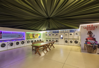 Self-service laundry room at hu Park Albatros Village, a family holiday park located in Tuscany, Italy.