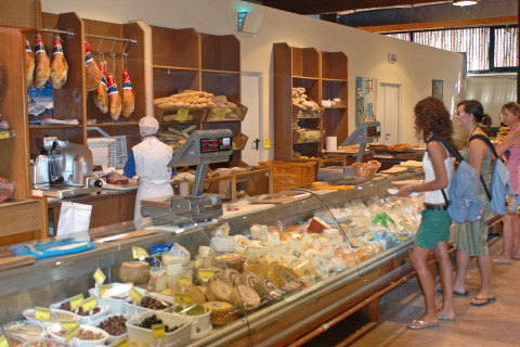 Guests shop at the deli counter in Park Albatros Village, a holiday park located in Tuscany, Italy.