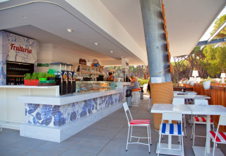 Modern bar and café area at Camping Village Roma Capitol holiday park in Tuscany, Italy.