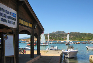 Barche e barche a vela al porto del Centro Vacanze Isuledda in Sardegna, Italia, in una giornata di sole.