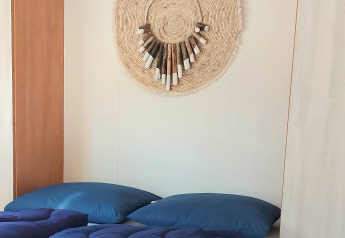 Modern bedroom at Beach House in Beloofde Land, Netherlands, with blue bedding and woven decor on the wall.