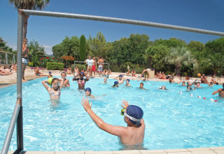 Children playing in the swimming pool at Camping Leï Suves holiday park in Provence-Alpes-Côte d’Azur, France.
