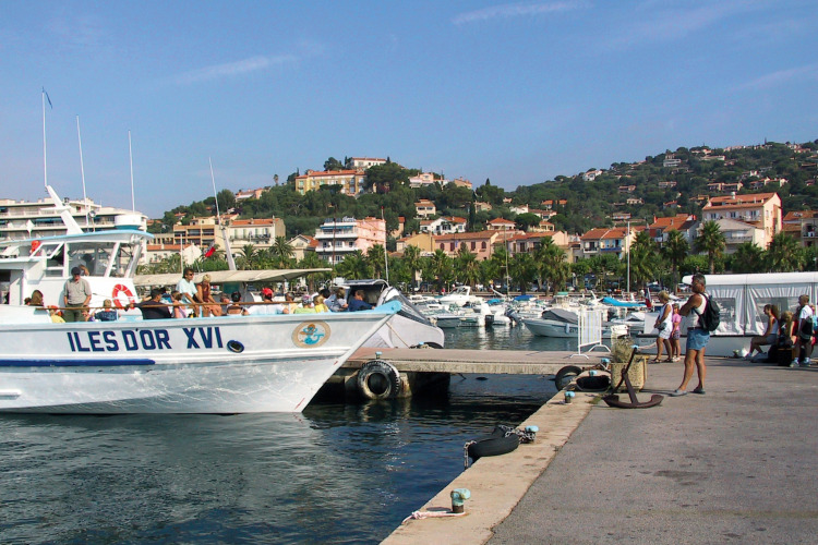 Harbor with boats and people near Camping Leï Suves, Provence-Alpes-Côte d’Azur, France.