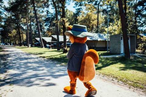 Mascotte con costume da scoiattolo e cappello cammina a Eurocamping Vessem BV, Paesi Bassi.