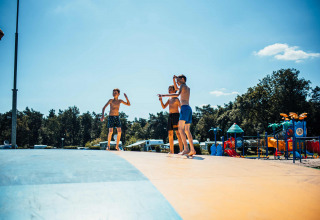 Bambini che giocano su un cuscino saltellante al parco vacanze Eurocamping Vessem BV in Brabante Settentrionale, Paesi Bassi.